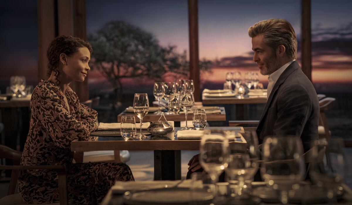 A man and woman sit across from each other at a restaurant