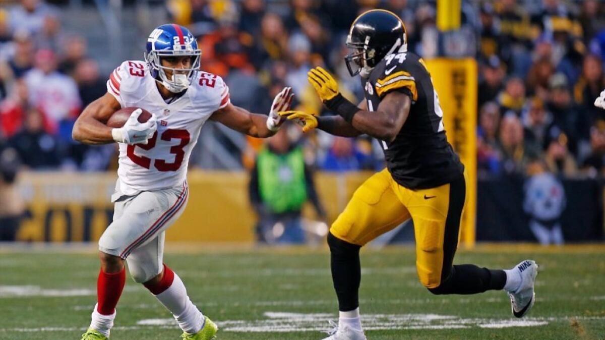 Giants running back Rashad Jennings works against Steelers linebacker Lawrence Timmons during a game on Dec. 4.