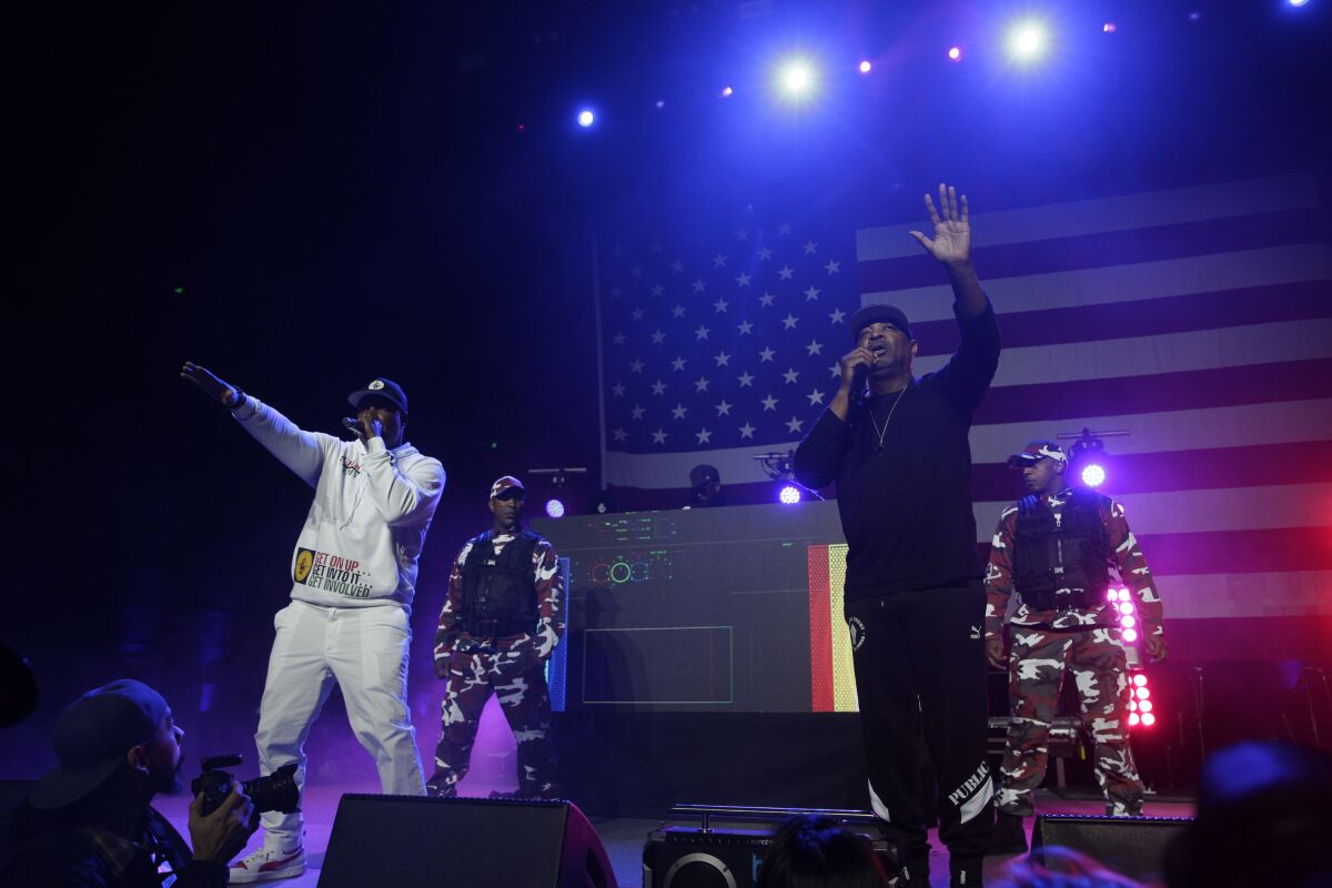 Performers onstage with an American flag behind them