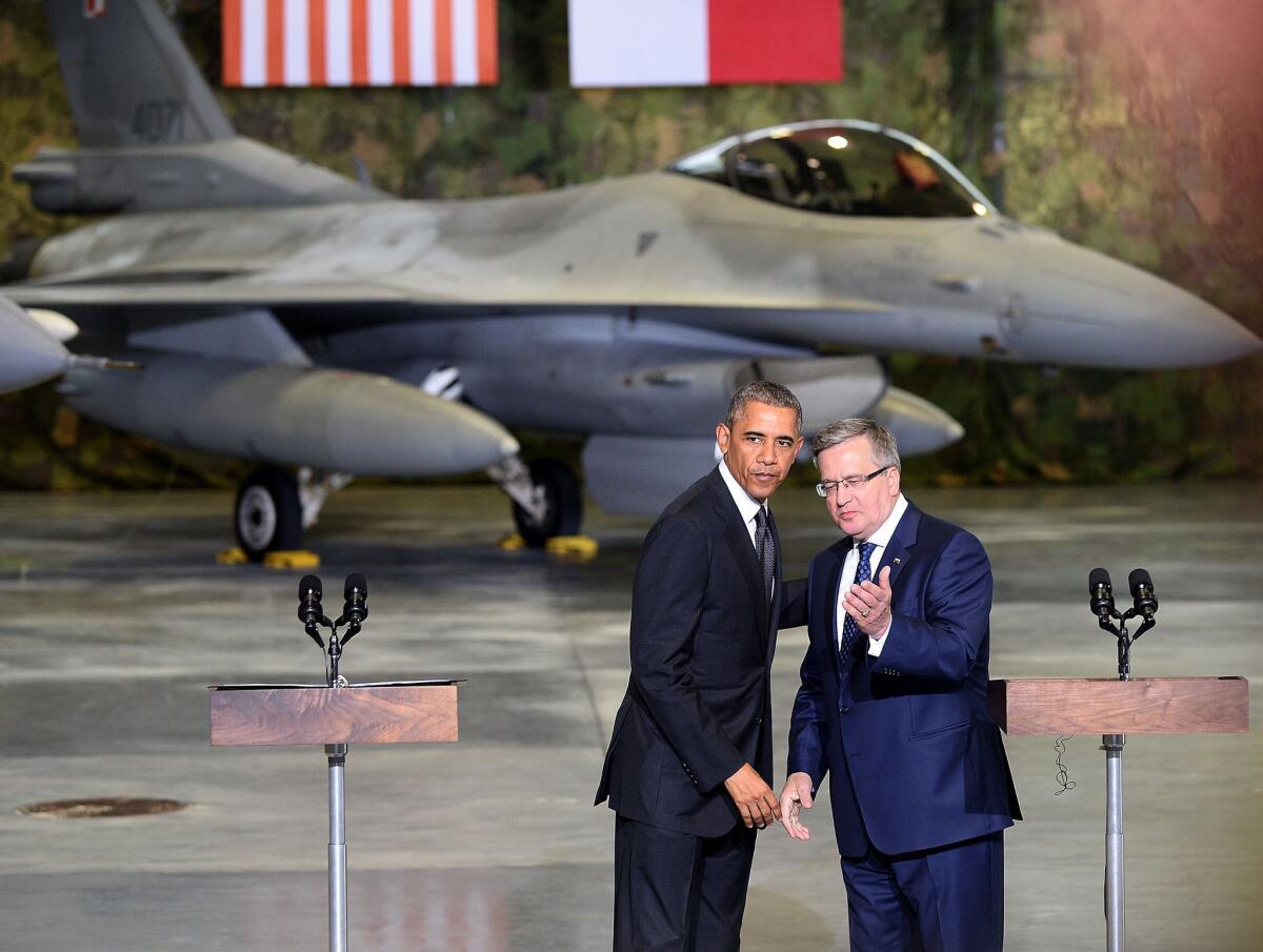 President Obama and Polish President Bronislaw Komorowski appear before U.S. and Polish airmen at Warsaw Chopin Airport. Poland is the first stop on a four-day European trip by Obama.