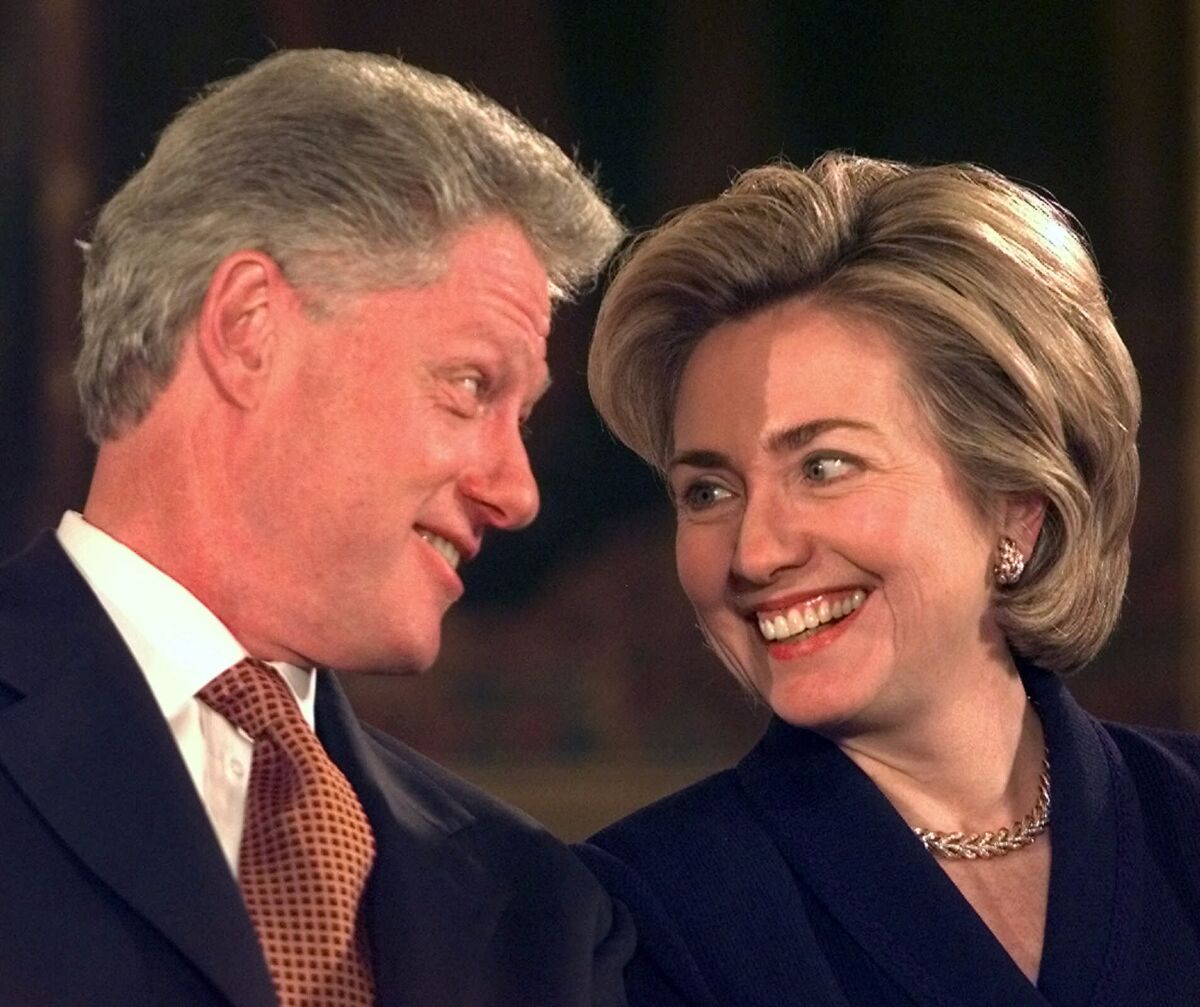 President Clinton and Hillary Rodham Clinton exchange smiles at a 1999 appearance.