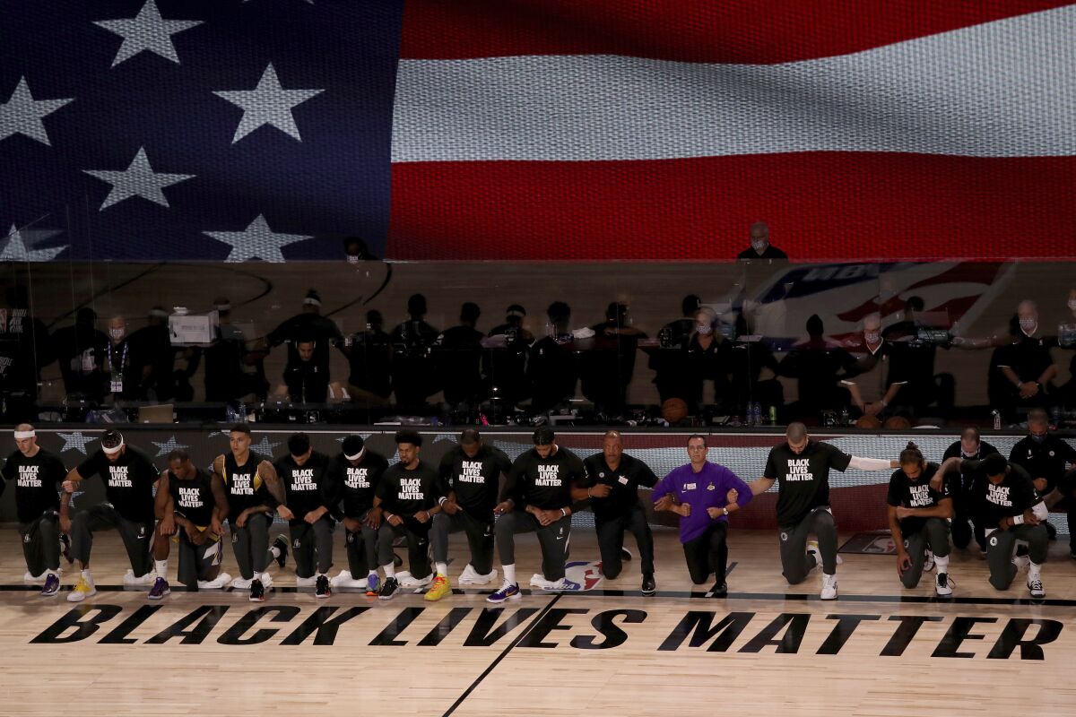 The Lakers and Clippers wear Black Lives Matter shirts and kneel during the national anthem before a game July 30.