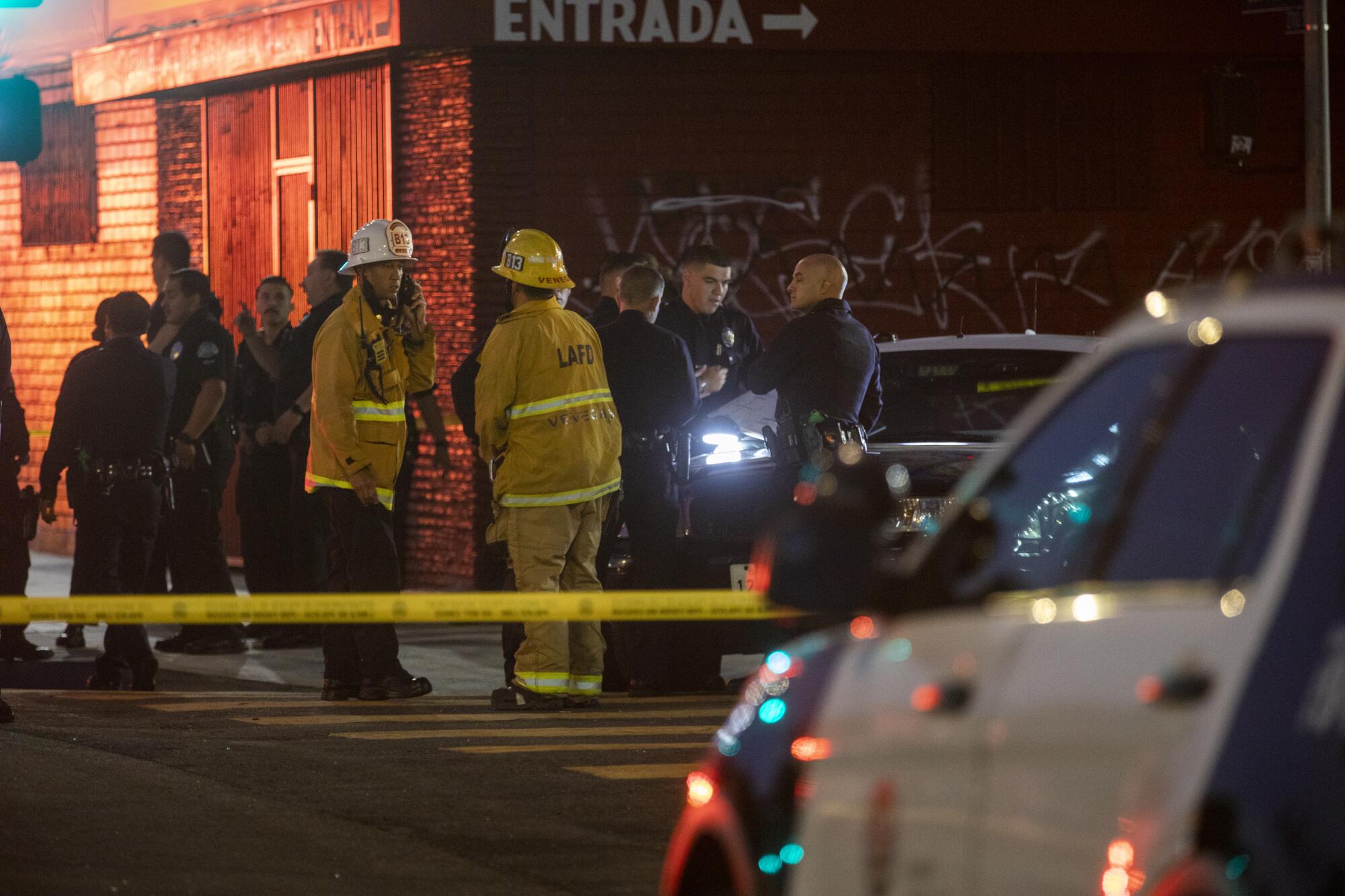 Fire and police personnel on a street.