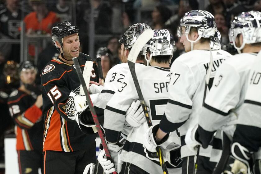 Ducks center Ryan Getzlaf (15) is greeted by members of the Kings after the Kings' 4-2 victory April 23, 2022.