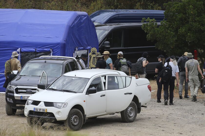 FILE - Police search teams arrive back to an operation tent near Barragem do Arade, Portugal, Tuesday May 23, 2023. German prosecutors say they will examine objects that were found in a search in Portugal last week for clues regarding the disappearance of Madeleine McCann, but can’t yet say whether they are linked to the British girl who went missing in 2007. (AP Photo/Joao Matos, File)
