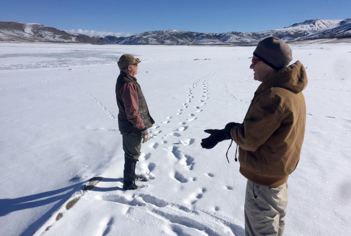 David Primus, who studies the history of the Gunnison Valley, right, and Bob Robbins look for remnants of Iola, flooded in the early 1960s to make way for Blue Mesa Reservoir, the largest body of water in Colorado.