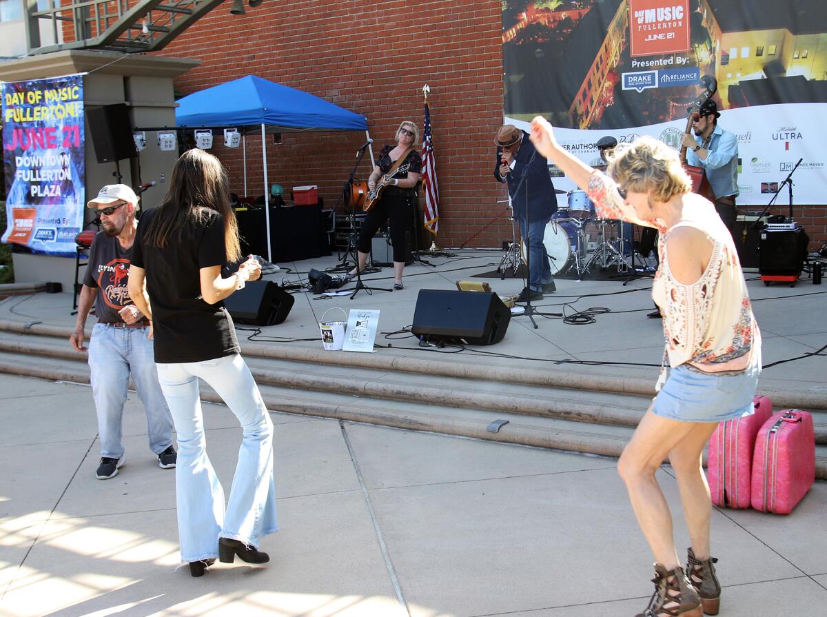 People dance to the Jessica Kaczmarek Band during ninth annual Day of Music Fullerton.