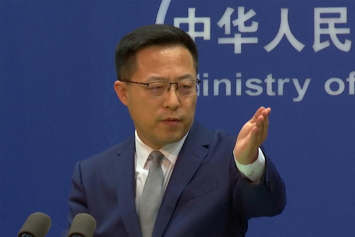 FILE - In this image made from video, Chinese Foreign Ministry spokesperson Zhao Lijian gestures during a media briefing at the Ministry of Foreign Affairs office, on Wednesday, April 6, 2022, in Beijing. China's government on Thursday, June 2, 2022, accused Washington of jeopardizing peace after U.S. envoys began trade talks with Taiwan aimed at deepening relations with the self-ruled island democracy claimed by Beijing as part of its territory. (AP Photo/Liu Zheng, File)