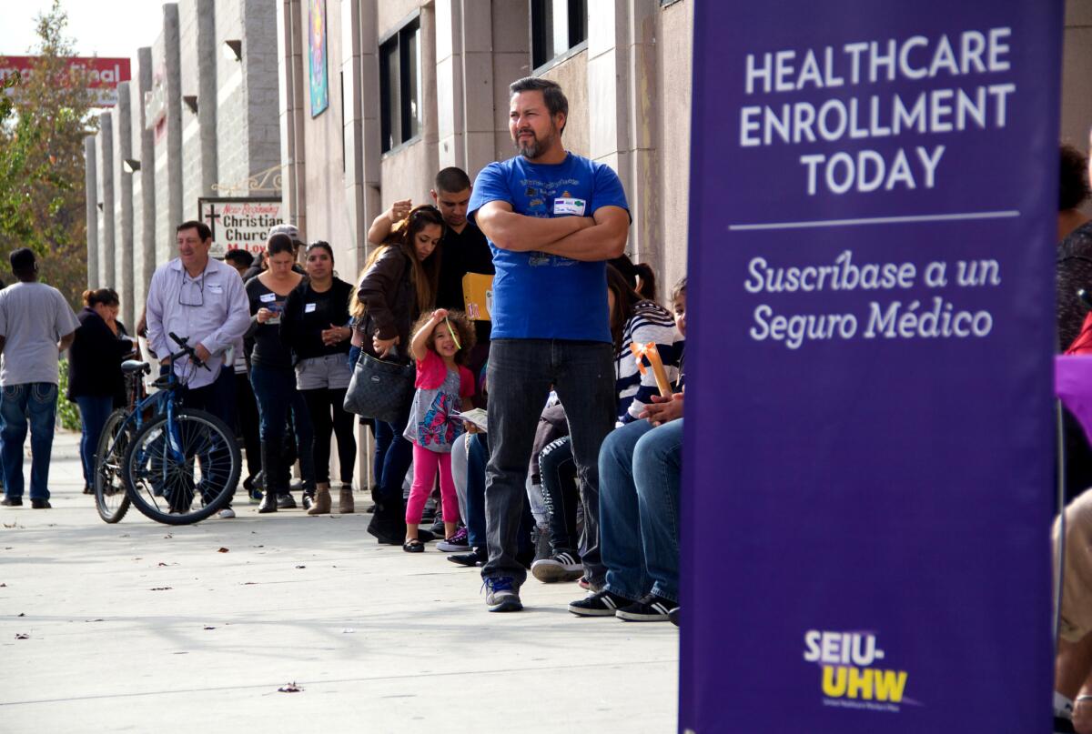 People wait to enter an Affordable Care Act enrollment event sponsored by SEIU-United Healthcare Workers West and Community Coalition, in Los Angeles on Saturday, Nov. 15, 2014.