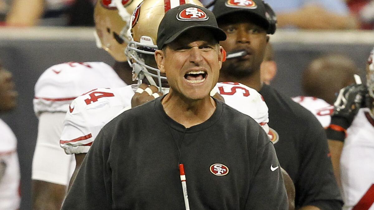 San Francisco 49ers Coach Jim Harbaugh disagrees with a referee's call during a preseason game against the Houston Texans on Aug. 28.