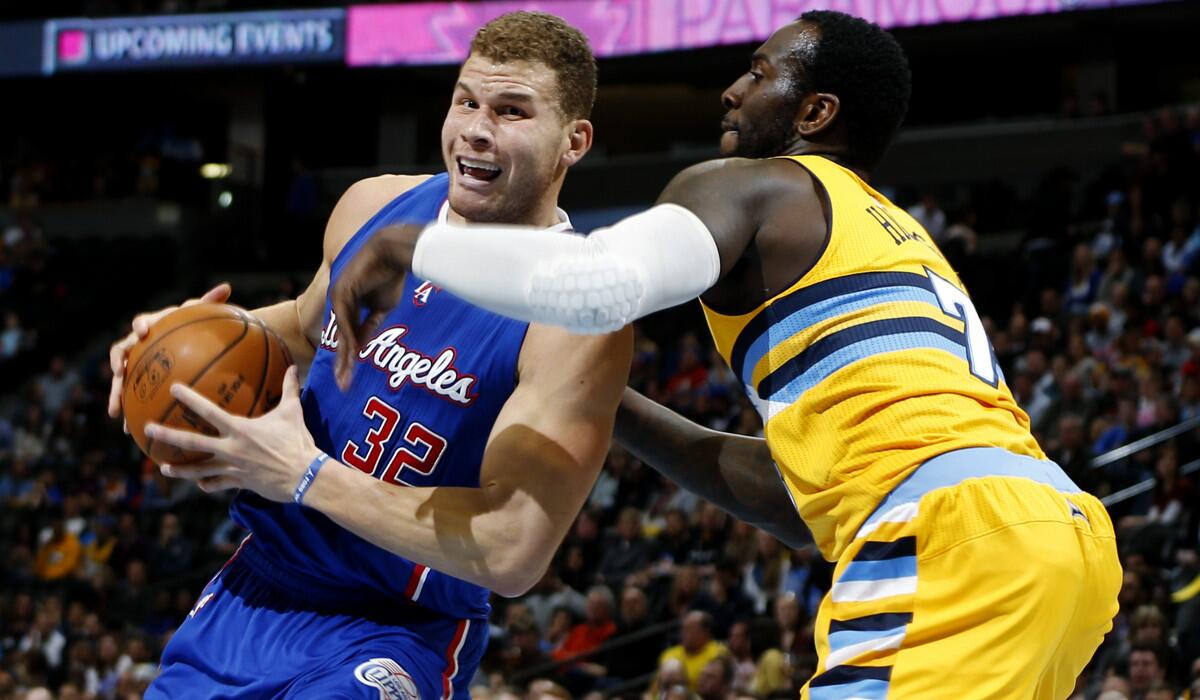 Clippers forward Blake Griffin (32) is fouled as he drives to the basket against Nuggets forward J.J. Hickson in the first half Friday night in Denver.