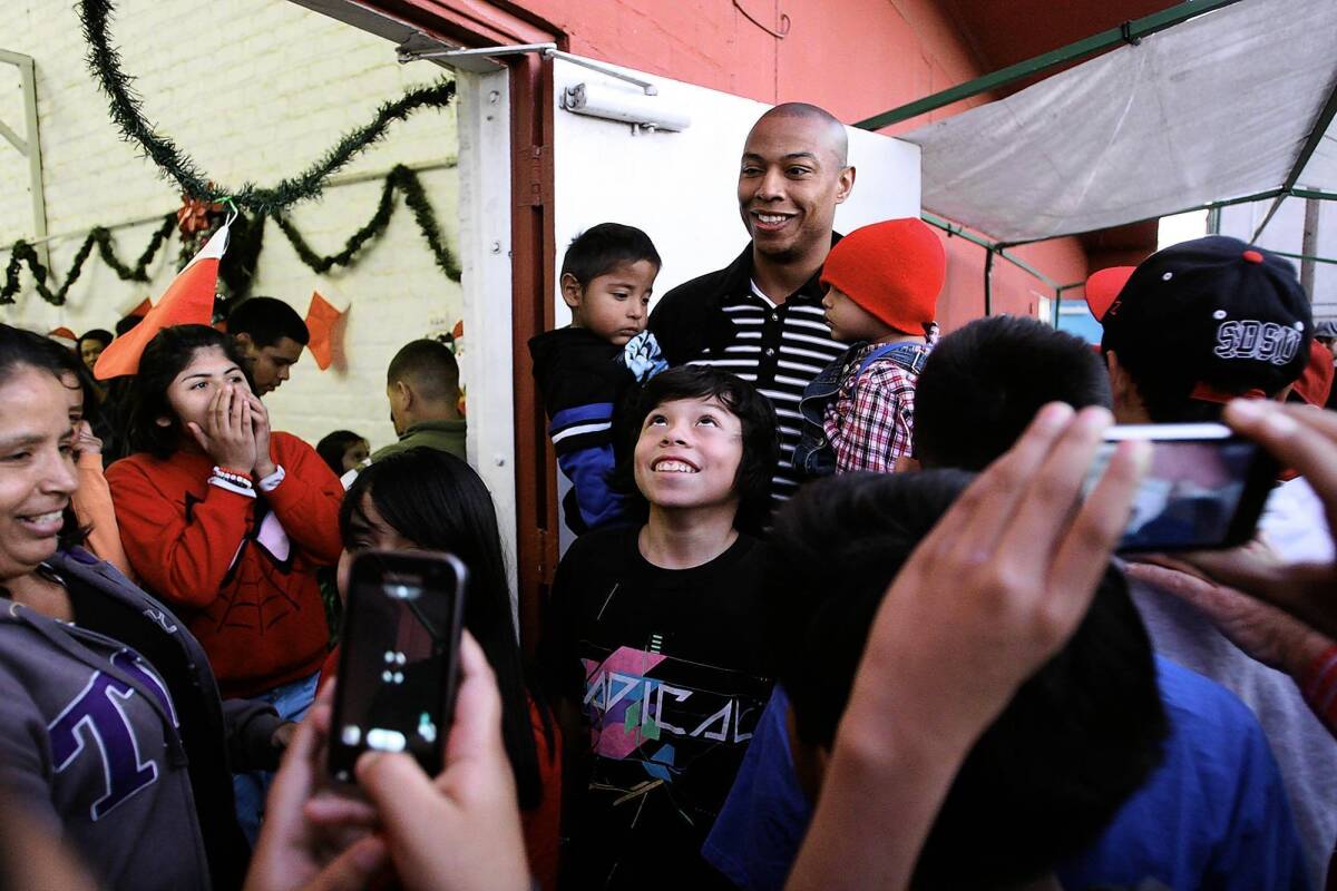 L.A. Clipper Caron Butler joins in the L.A. Boys and Girls Club holiday party. During the event, Bike Nation announced that it would begin rolling out its bike-share program in April.