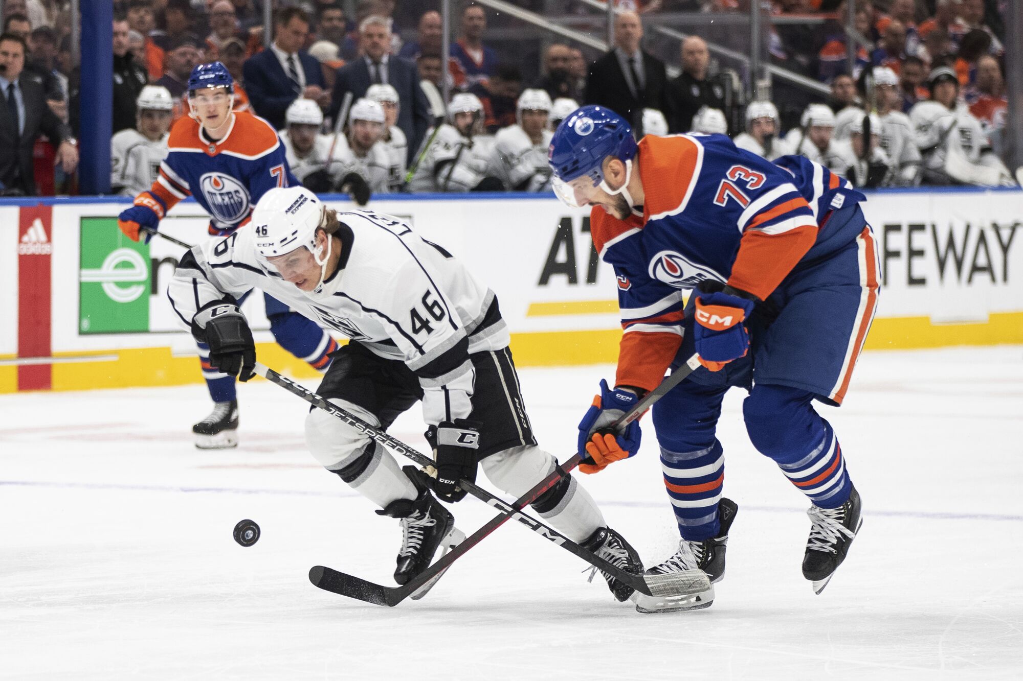 Kings' Blake Lizotte and Edmonton Oilers' Vincent Desharnais vie for the puck.