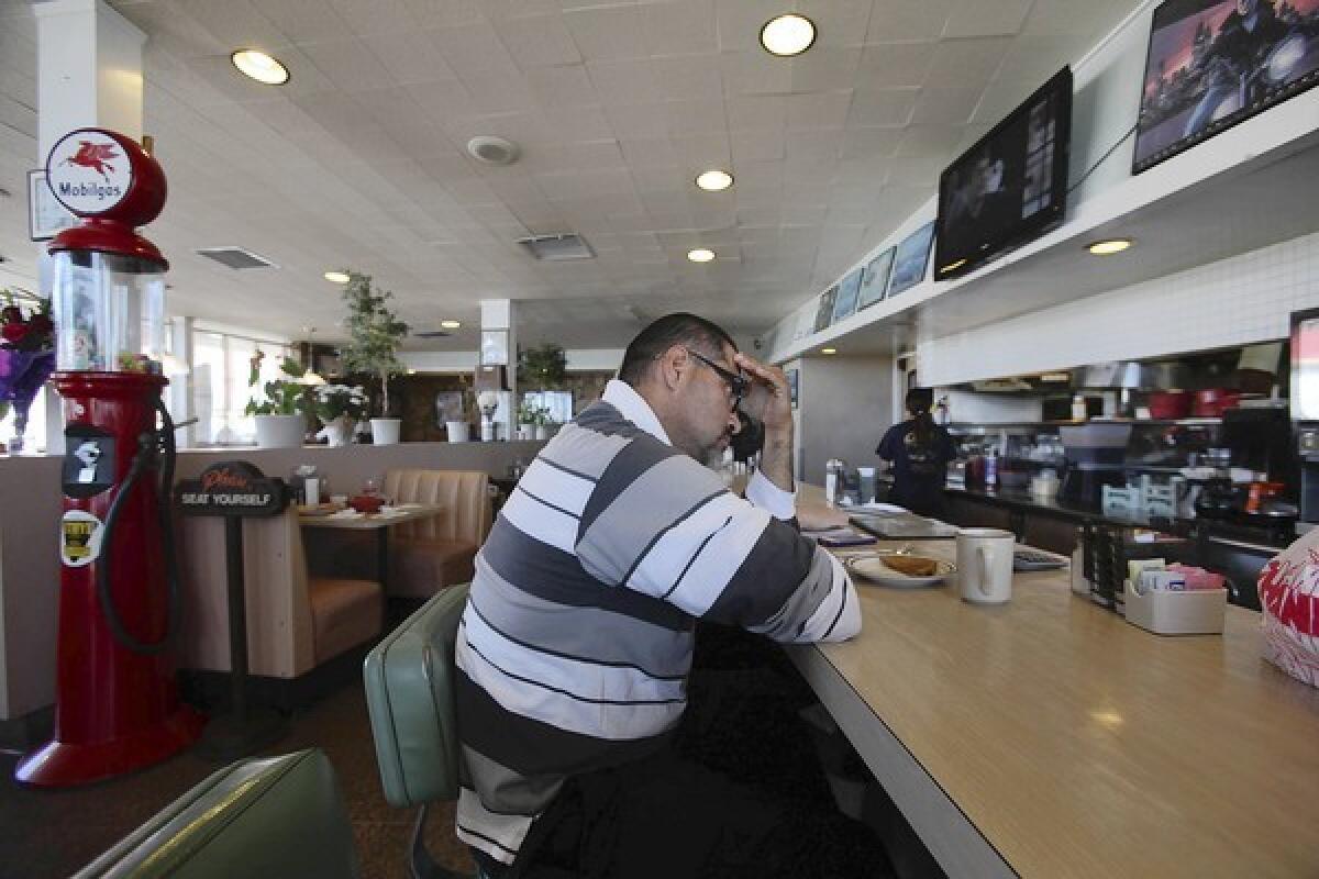 Marco Orozco sits at the counter at Chips diner in Hawthorne. Orozco was a friend of Filimon Lamas, part-owner of the diner, who was killed by a gunman who broke into his Inglewood home.