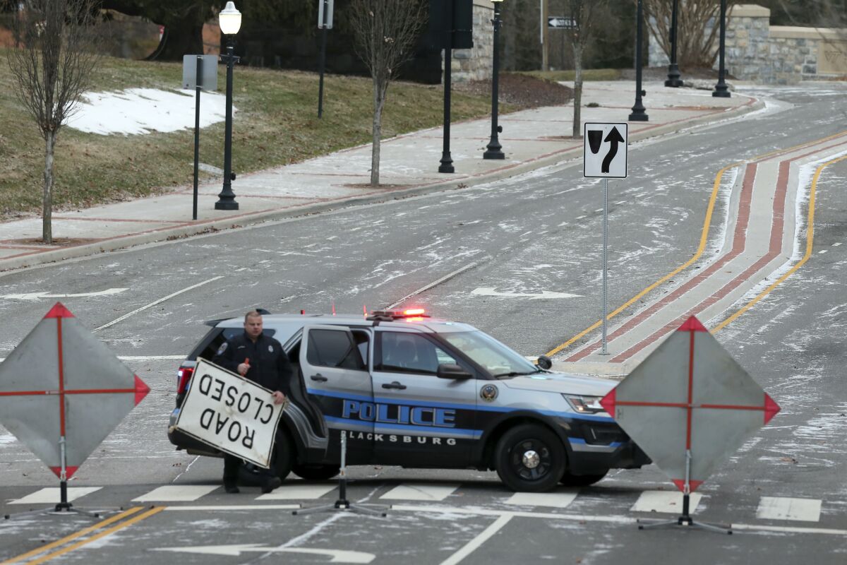 Main Street was closed as police conduct a shooting investigation in Blacksburg Va., on Saturday, Feb. 5 2022. A gunman accused of opening fire inside a hookah lounge was arrested late Saturday night. (Matt Gentry/The Roanoke Times via AP)