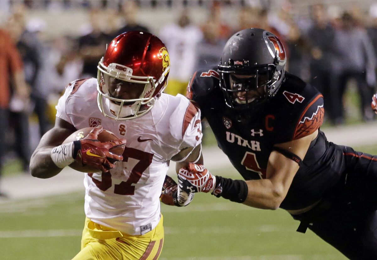 USC running back Javorius Allen is tackled by Utah defensive back Brian Blechen during the fourth quarter of the Trojans' 24-21 loss to the Utes.