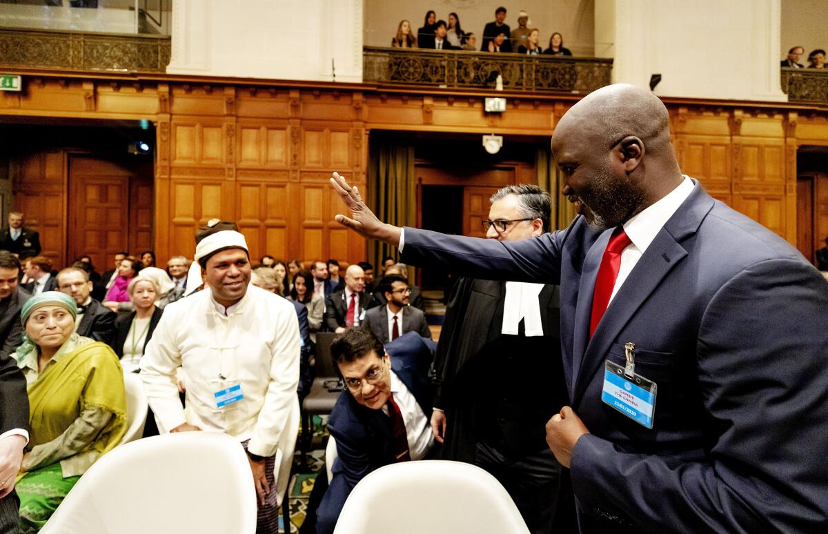 Aboubacarr Tambadou, Gambia's justice minister, waves to a representative of the Rohingya community Jan. 22 at the United Nations' International Court of Justice in The Hague.