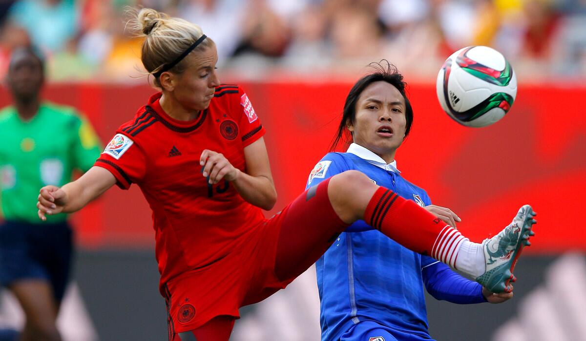 Germany's Jennifer Cramer, left, challenges Thailand's Kanjana Sung-Ngoen for the ball during a match in the FIFA Women's World Cup on Monday.