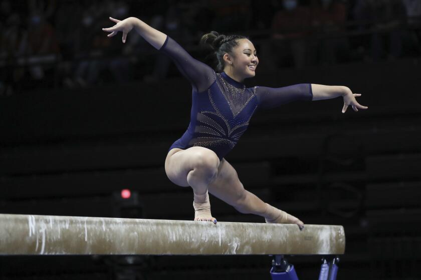 UCLA's Emma Malabuyo competes on the balance beam during an NCAA gymnastics.
