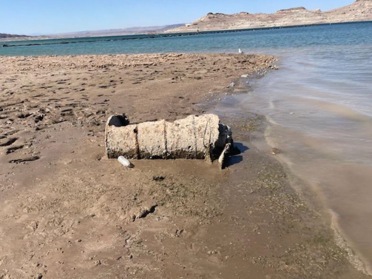 A muddy barrel on the dry bed of Lake Mead.