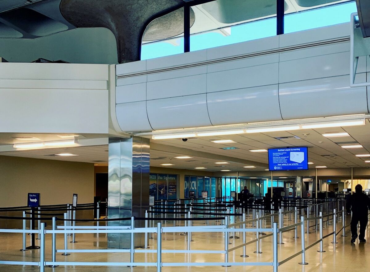 The San Diego airport's Terminal 1 has no lines for security screening amid the COVID-19 pandemic, which has discouraged most people from flying.