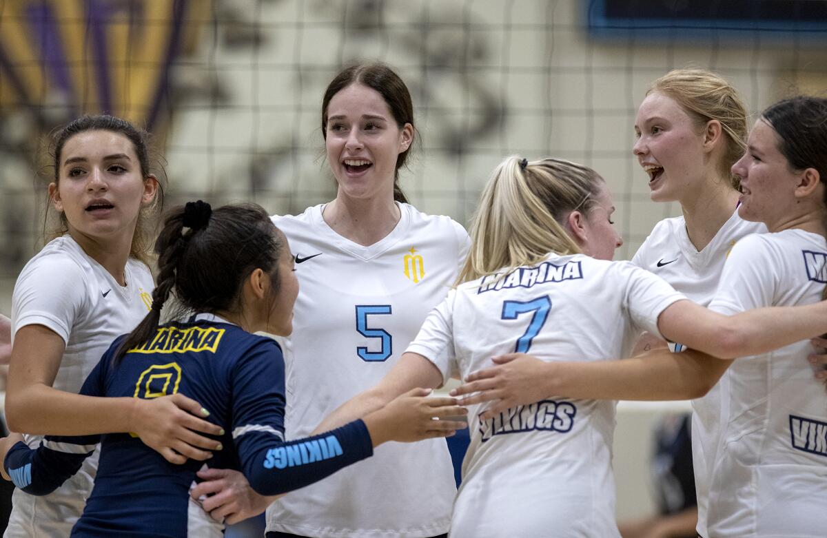 The Marina girls' volleyball team celebrates a point against Pacifica during a nonleague match on Wednesday.