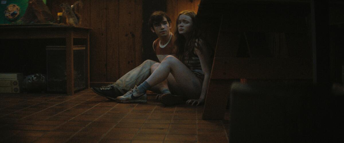 Two scared kids sit on the floor in a scene from "Fear Street Part 2: 1978"