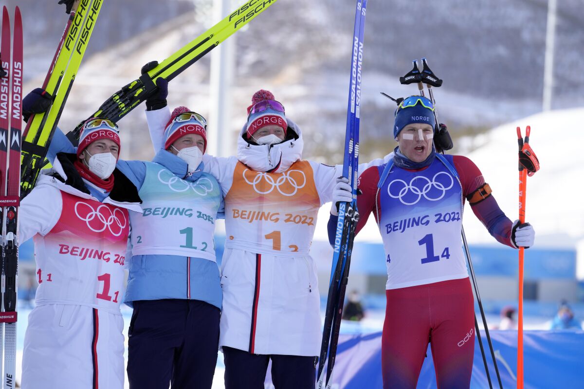 From left, Sturla Holm Laegreid, Tarjei Boe, Johannes Thingnes Boe and Vetle Sjaastad Christiansen of Norway pose after their first place finish during the men's 4x7.5-kilometer relay at the 2022 Winter Olympics, Tuesday, Feb. 15, 2022, in Zhangjiakou, China. (AP Photo/Kirsty Wigglesworth)