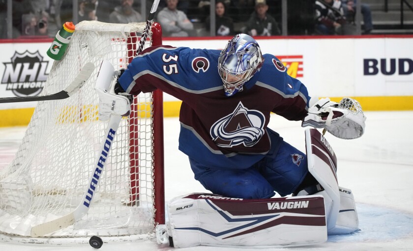 Colorado Avalanche goaltender Darcy Kuemper collects the puck in the second period of an NHL hockey game against the Calgary Flames, Sunday, March 13, 2022, in Denver. (AP Photo/David Zalubowski)