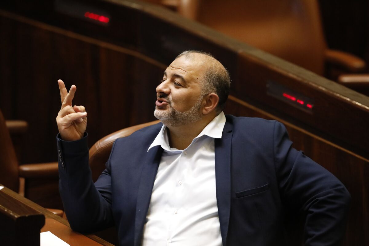 FILE - Mansour Abbas attends a Knesset session in Jerusalem, June 13, 2021. Abbas, head of the Islamist Arab Ra'am party, a key Israeli governing partner, said Wednesday, May 11, 2022, that said he would continue his party's membership in the country's fragile coalition, averting another crises for the embattled government following tensions at a key Jerusalem holy site in recent weeks. (AP Photo/Ariel Schalit, File)
