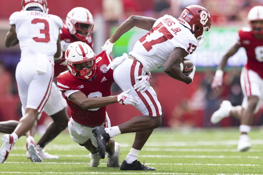 Nebraska's Tommi Hill (0) tackles Oklahoma's Marvin Mims Jr. (17) during the first half of an NCAA college football game Saturday, Sept. 17, 2022, in Lincoln, Neb. (AP Photo/Rebecca S. Gratz)