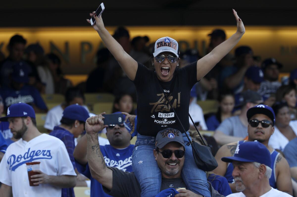 Fans get ready for the start of Game 1 of the World Series between the Dodgers and the Houston Astros at Dodger Stadium.