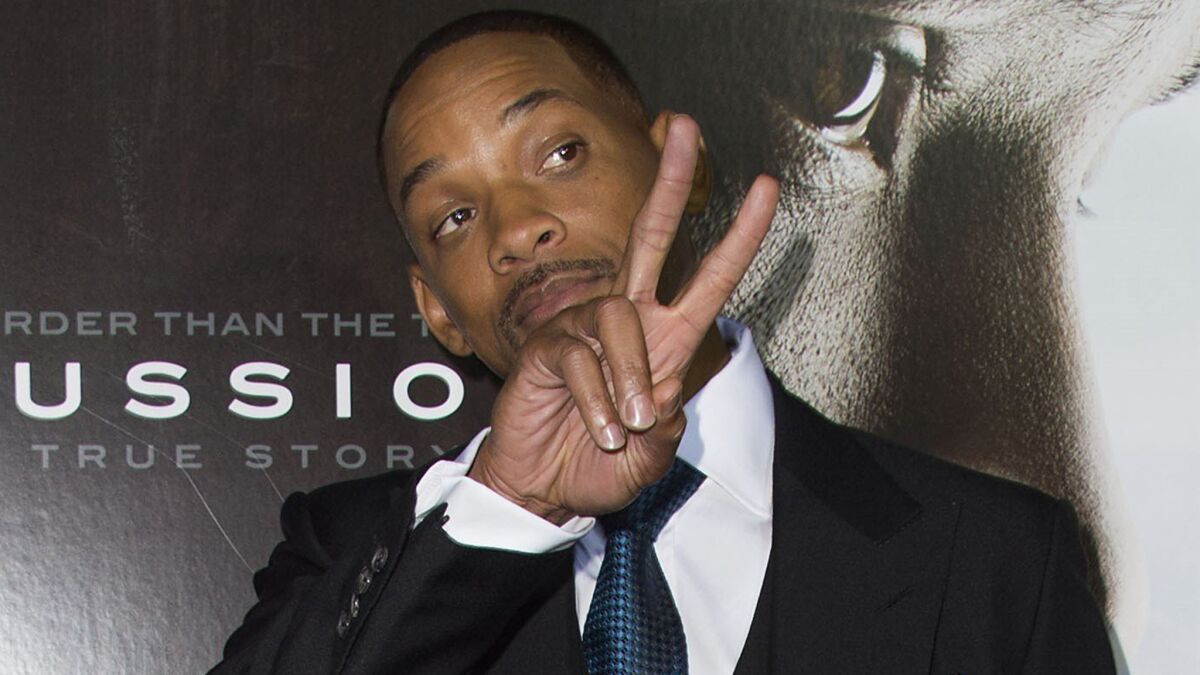 Will Smith shows off a basic political skill at a special screening of "Concussion" on Monday in Westwood.