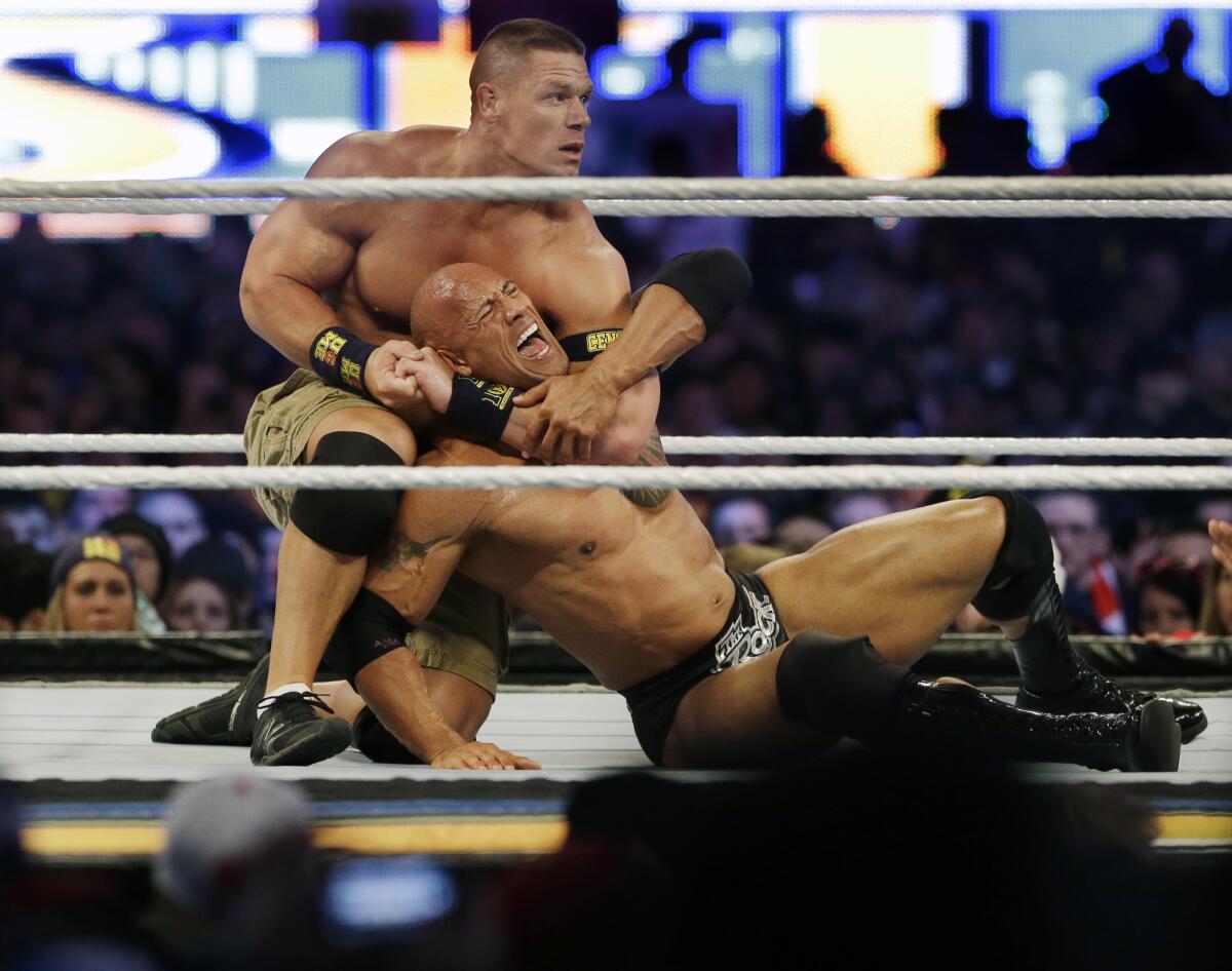 John Cena puts The Rock into a chokehold at WrestleMania in 2013. 