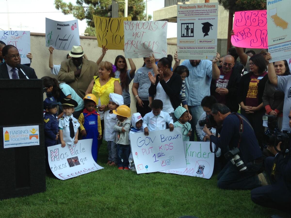 Los Angeles County Supervisor Mark Ridley-Thomas, left, speaks to education advocates at a rally outside the Twin Towers jail facility in downtown Los Angeles.