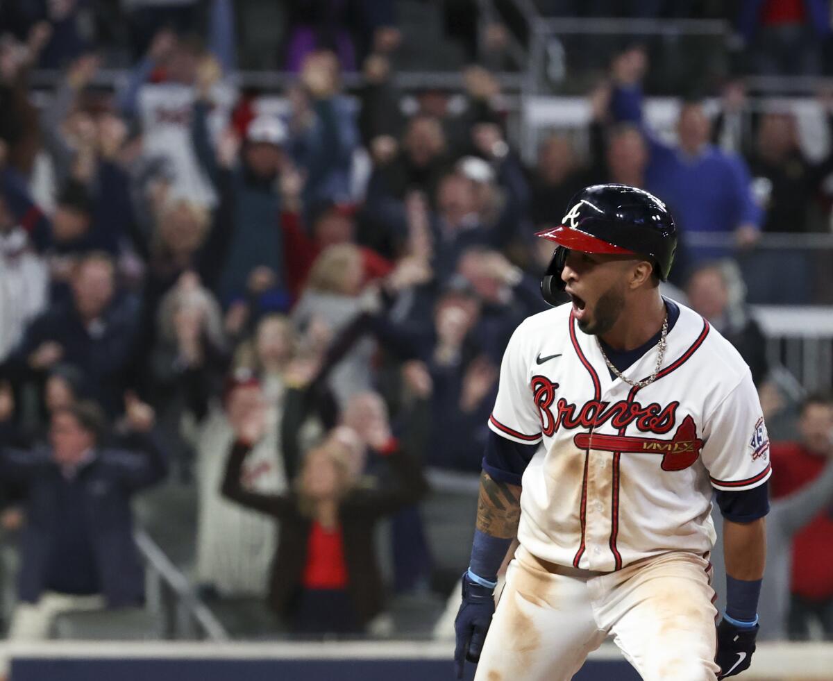 Atlanta's Eddie Rosario celebrates after hitting a walk-off single to defeat the Dodgers.