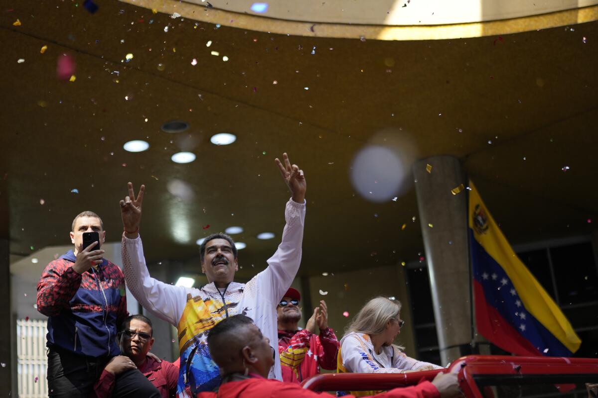 Venezuelan President Nicolás Maduro gestures to supporters.