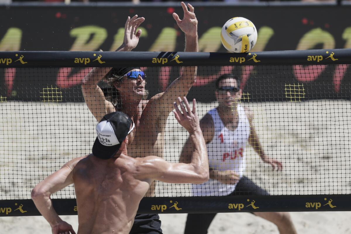 David Lee knocks the ball past Ed Ratledge during first set action of elimination round match at the AVP Hermosa Beach Open.
