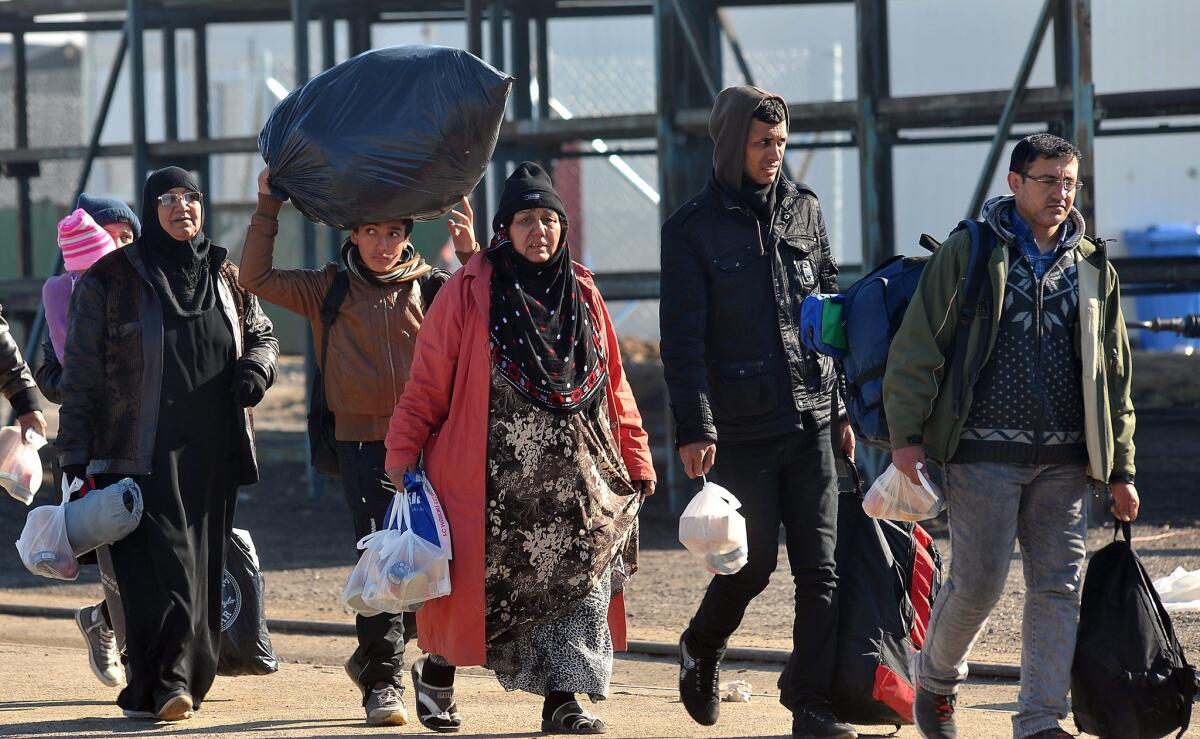 Migrants and refugees carrying their belongings arrive at a transit camp in Slavonski Brod, Croatia on Nov. 4. Bernie Sanders, among others, has made statements linking climate change to terrorism.
