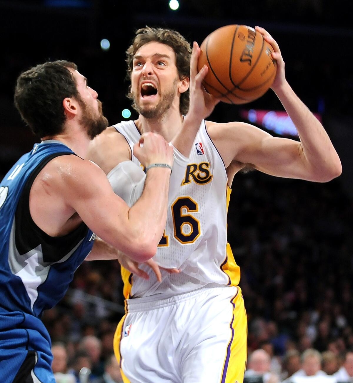 Lakers forward Pau Gasol, right, is fouled by Minnesota Timberwolves forward Kevin Love while driving to the basket during the first half of the Lakers' 113-90 loss Sunday at Staples Center.