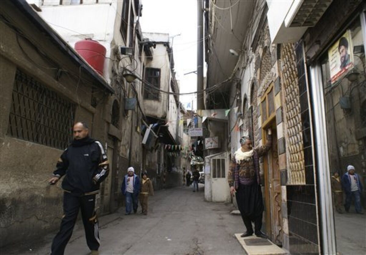 People walk in the alleys of the old city in Damascus, Syria, Thursday, Dec. 25, 2008. Development spurred by a shift toward a free market economy is threatening the old quarter of Damascus as aggressive investors flush with cash have pushed property prices so high that more and more homeowners are selling their homes and moving out. (AP Photo/Ola al Rifai) NO IONLN **