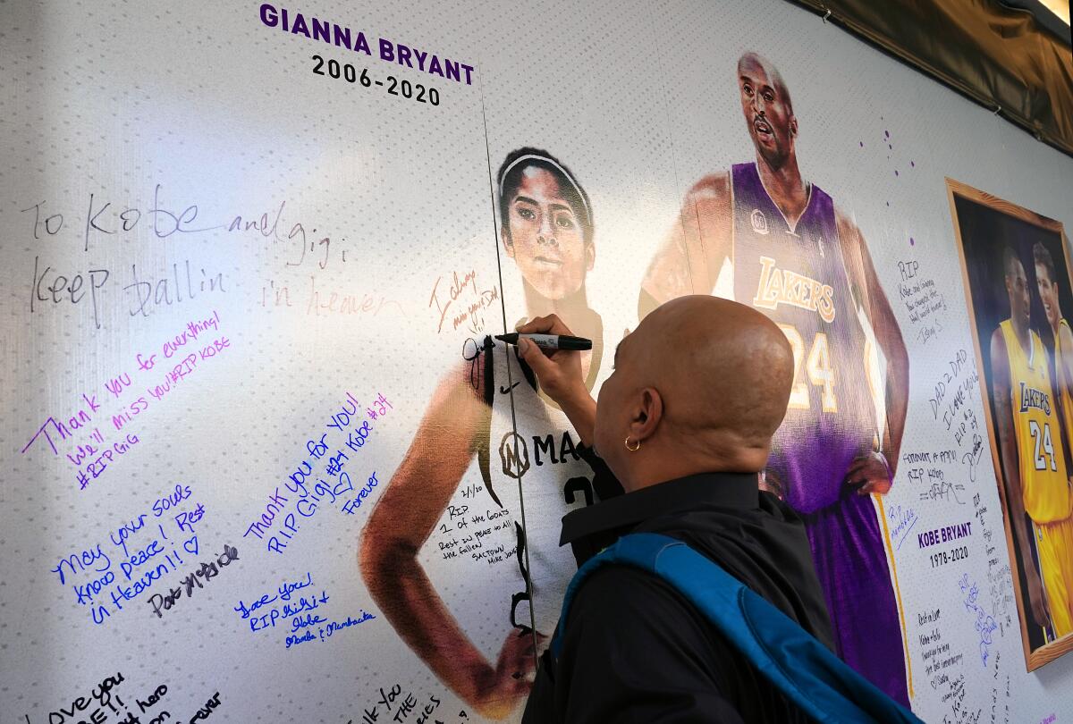 Fans honor Kobe Bryant and his daughter Gianna at an art installation wall in the plaza across from Golden 1 Center in Sacramento on Feb. 2, 2020.