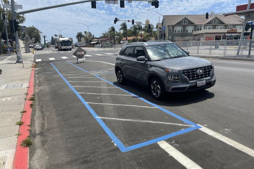 A recently painted handicap parking spot sits to the right of the new bike lane along Park Boulevard in University Heights on Wednesday, June 22, 2022.