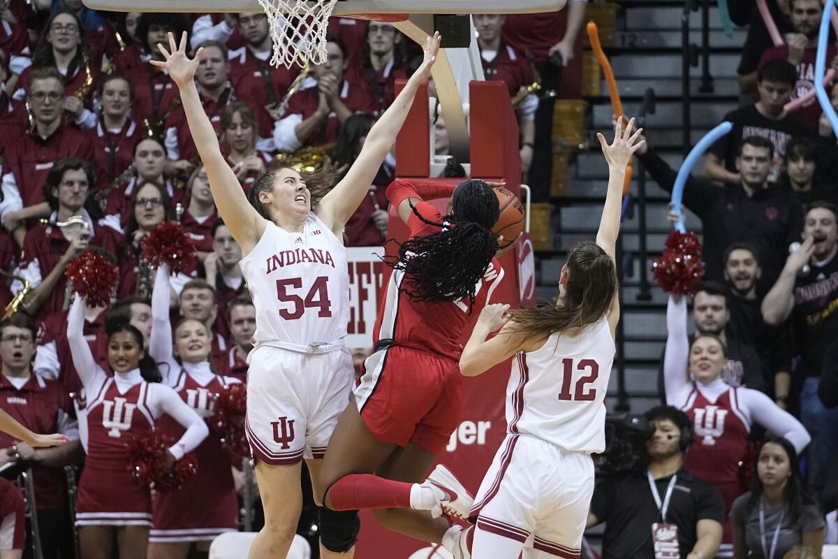 Ohio State's Cotie McMahon (32) shoots against Indiana's Mackenzie Holmes (54) and Yarden Garzon (12) during the second half of an NCAA college basketball game, Thursday, Jan. 26, 2023, in Bloomington, Ind. (AP Photo/Darron Cummings)