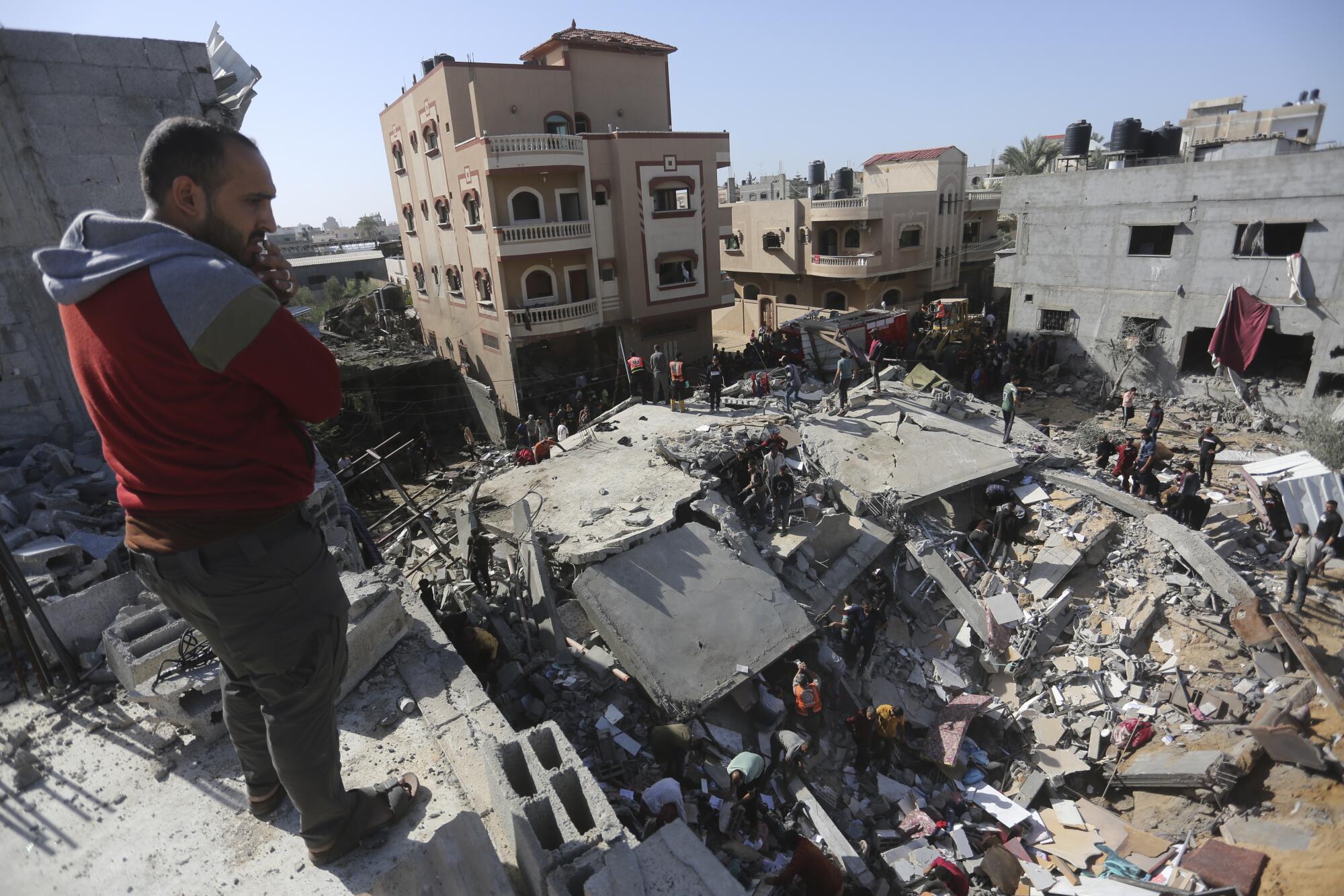 Man looking out on destruction from an Israeli strike on Gaza