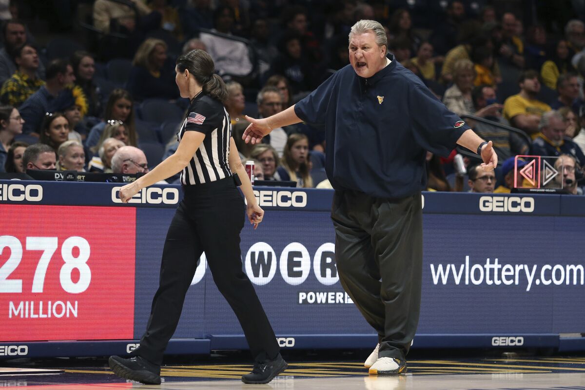 West Virginia coach Bob Huggins reacts to a call during the first half of the team's NCAA college basketball game against Radford in Morgantown, W.Va., Saturday, Dec. 4, 2021. (AP Photo/Kathleen Batten)