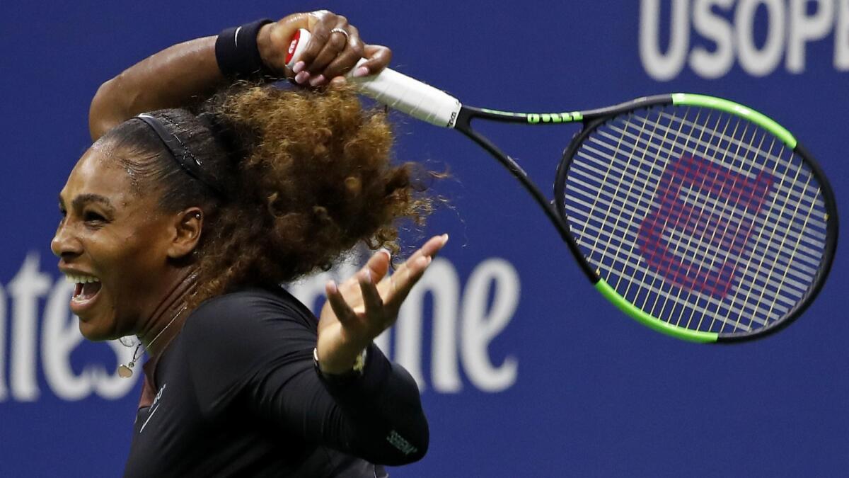 Serena Williams watches a return to Venus Williams.