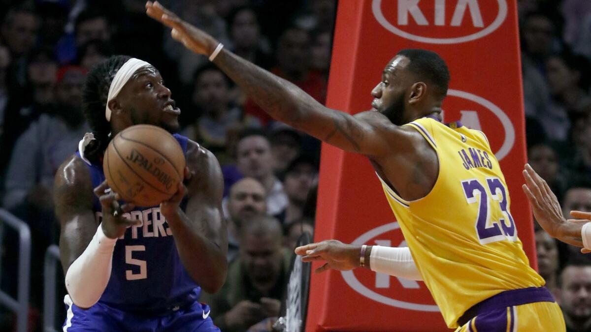 Lakers forward LeBron James defends against Clippers center Montrezl Harrell during a 123-120 win on Dec. 28.
