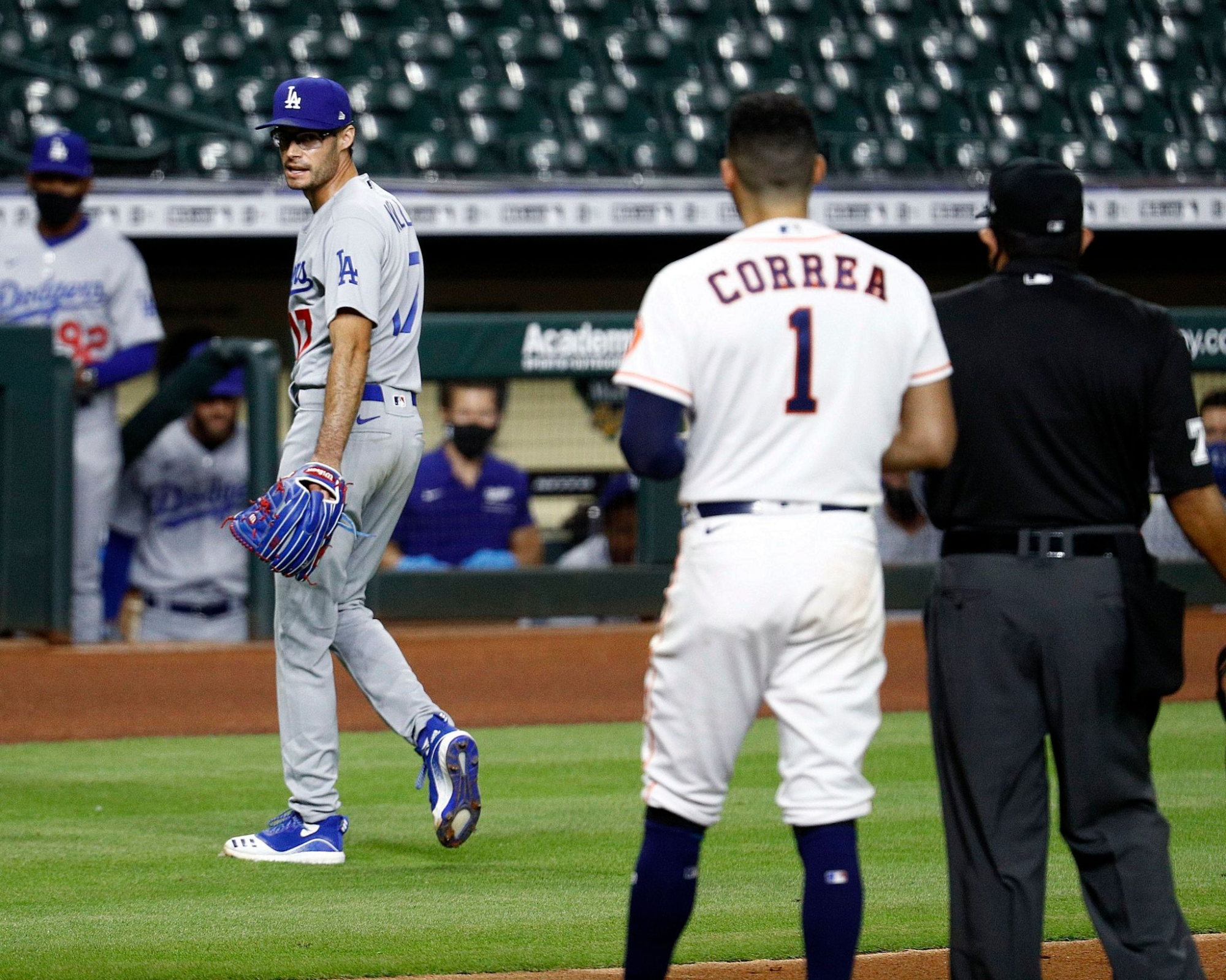 Dodgers' Joe Kelly has a word with Houston Astros' Carlos Correa as he walks off the mound.