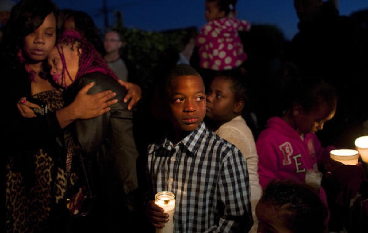 Tears stream down the face of 10-year-old James Dotson at a vigil Monday for his cousin Elawnza Peebles, 14, who was fatally shot as he was walking home Saturday evening.